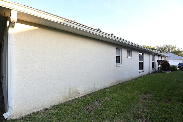 14112 Whitecap Ave, Hudson, FL 34667 - view of side of property featuring stucco siding and a yard