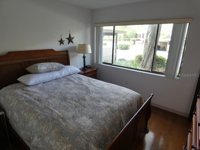 13010 Wedgewood Way Unit A, Hudson, FL 34667 - bedroom with wood finished floors and baseboards
