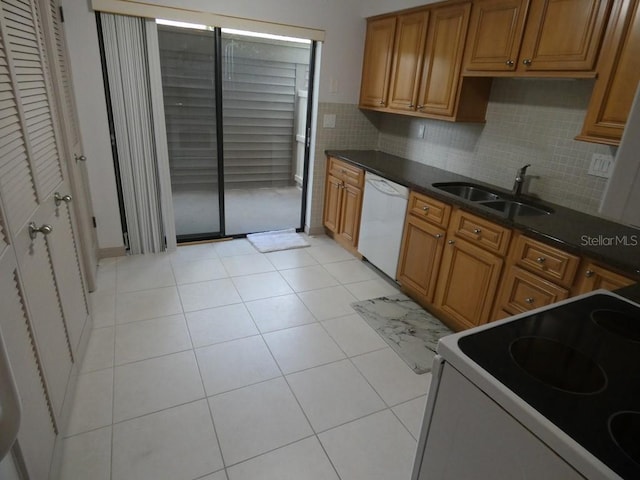 13010 Wedgewood Way Unit A, Hudson, FL 34667 - kitchen featuring white appliances, a sink, brown cabinetry, decorative backsplash, and light tile patterned flooring