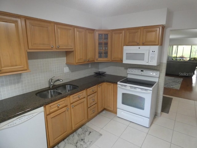 13010 Wedgewood Way Unit A, Hudson, FL 34667 - kitchen featuring white appliances, a sink, tasteful backsplash, and brown cabinets