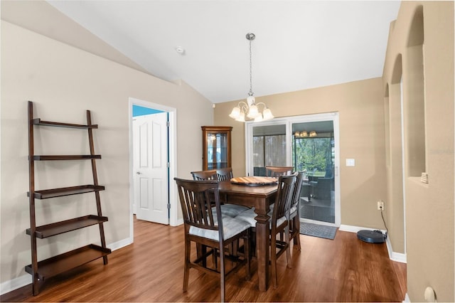 13444 English Parrot Rd, Brooksville, FL 34614 - dining room featuring vaulted ceiling, a chandelier, baseboards, and wood finished floors