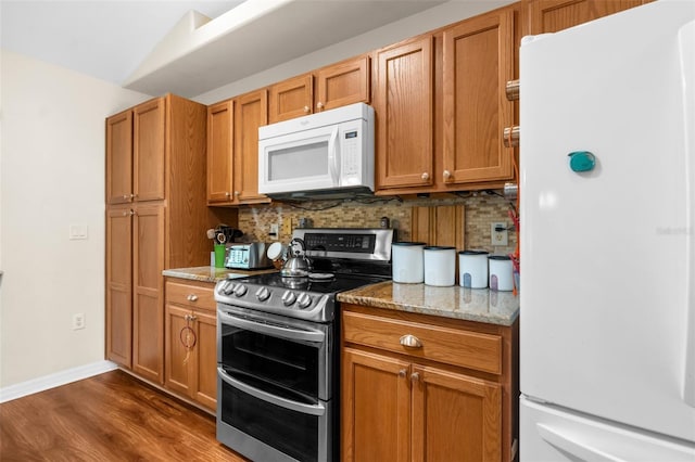 13444 English Parrot Rd, Brooksville, FL 34614 - kitchen with white appliances, decorative backsplash, dark wood-type flooring, light stone countertops, and brown cabinets