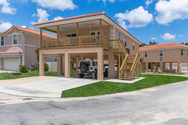 10234 W Middlburg Loop Unit 152, Homosassa, FL 34448 - view of front of property featuring a carport, a tile roof, ceiling fan, concrete driveway, and stucco siding