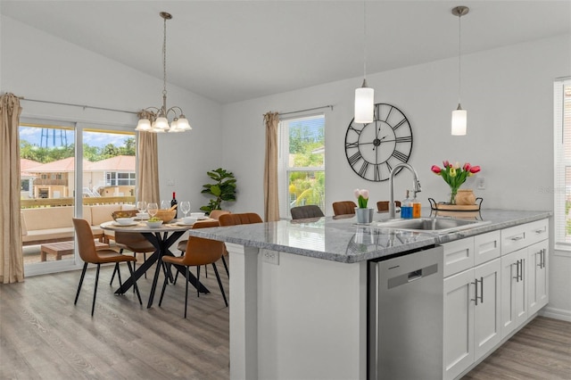 10234 W Middlburg Loop Unit 152, Homosassa, FL 34448 - kitchen featuring dishwasher, light wood-style flooring, a sink, lofted ceiling, and pendant lighting