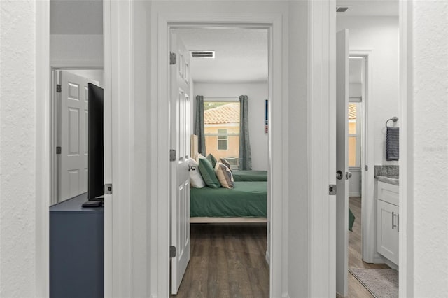 10234 W Middlburg Loop Unit 152, Homosassa, FL 34448 - corridor featuring dark wood-style flooring and a textured wall