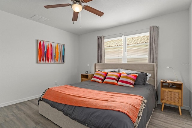10234 W Middlburg Loop Unit 152, Homosassa, FL 34448 - bedroom with wood finished floors, baseboards, and a ceiling fan