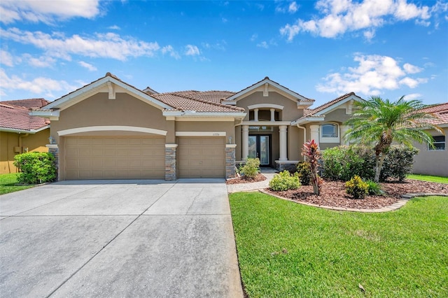 11726 Belle Haven Dr, New Port Richey, FL 34654 - view of front facade featuring stucco siding, a garage, driveway, a tile roof, and a front lawn