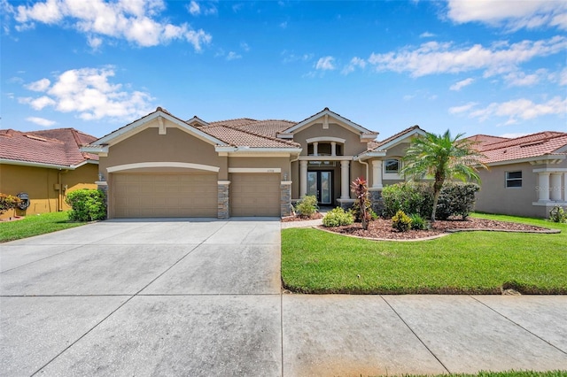 11726 Belle Haven Dr, New Port Richey, FL 34654 - view of front of house with stucco siding, an attached garage, a front lawn, driveway, and a tile roof