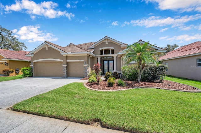 11726 Belle Haven Dr, New Port Richey, FL 34654 - view of front of house featuring stucco siding, an attached garage, a front lawn, concrete driveway, and french doors