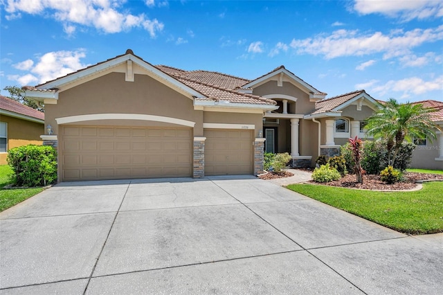 11726 Belle Haven Dr, New Port Richey, FL 34654 - view of front of house with stucco siding, an attached garage, a tile roof, and driveway