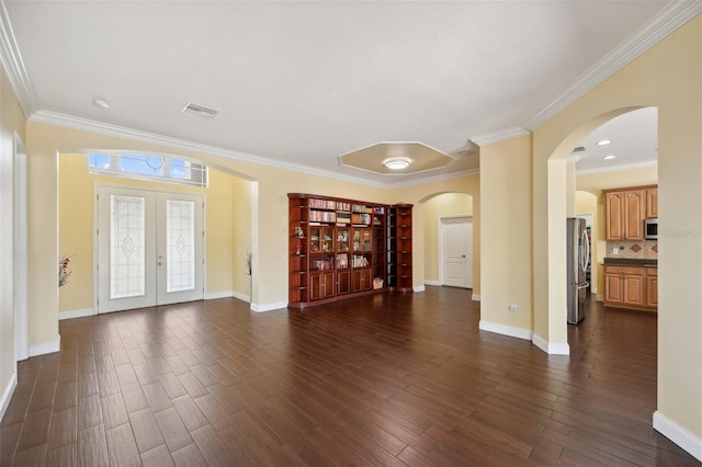 11726 Belle Haven Dr, New Port Richey, FL 34654 - unfurnished living room with arched walkways, dark wood-style floors, crown molding, baseboards, and french doors