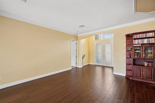 11726 Belle Haven Dr, New Port Richey, FL 34654 - unfurnished room featuring baseboards, french doors, dark wood finished floors, crown molding, and arched walkways
