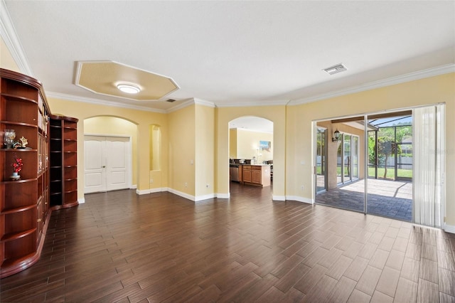 11726 Belle Haven Dr, New Port Richey, FL 34654 - empty room featuring arched walkways, dark wood-style floors, ornamental molding, and baseboards