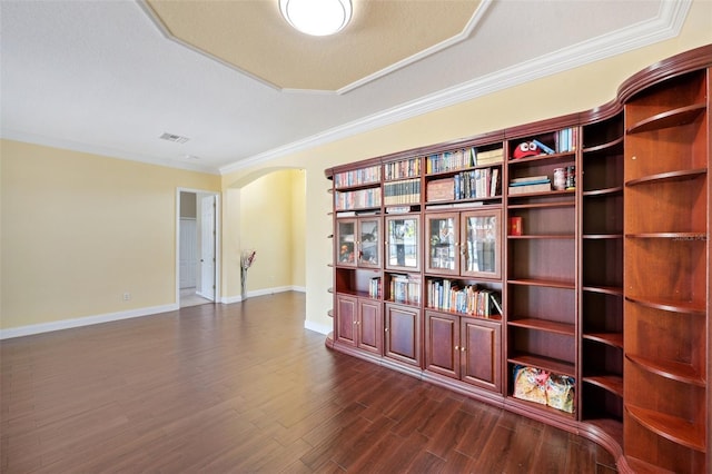 11726 Belle Haven Dr, New Port Richey, FL 34654 - spare room with arched walkways, dark wood-style flooring, crown molding, and baseboards