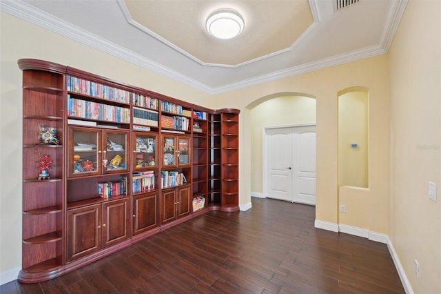 11726 Belle Haven Dr, New Port Richey, FL 34654 - empty room with arched walkways, dark wood-type flooring, a raised ceiling, ornamental molding, and baseboards