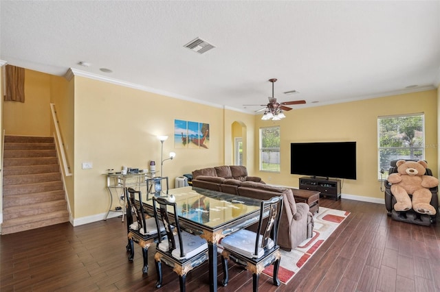 11726 Belle Haven Dr, New Port Richey, FL 34654 - dining area with dark wood-style floors, stairway, ceiling fan, baseboards, and crown molding