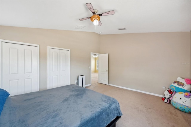 11726 Belle Haven Dr, New Port Richey, FL 34654 - bedroom featuring vaulted ceiling, two closets, light colored carpet, baseboards, and a ceiling fan