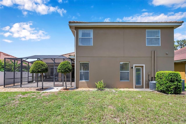 11726 Belle Haven Dr, New Port Richey, FL 34654 - back of property with a patio, stucco siding, a lanai, and central AC unit
