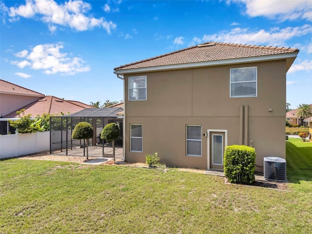 11726 Belle Haven Dr, New Port Richey, FL 34654 - back of house featuring central AC unit, stucco siding, a tiled roof, and a patio