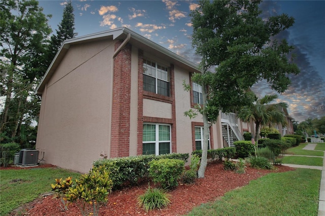6338 Spring Flower Dr Unit 21, New Port Richey, FL 34653 - view of home's exterior with central AC unit and stucco siding