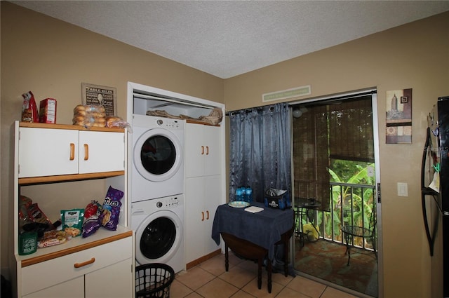 6338 Spring Flower Dr Unit 21, New Port Richey, FL 34653 - washroom featuring stacked washing machine and dryer, light tile patterned floors, and a textured ceiling