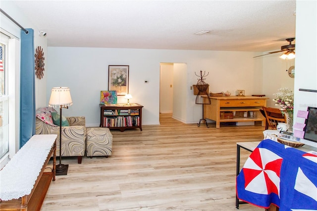 9630 Eldridge Rd, Spring Hill, FL 34608 - living area featuring wood finished floors, ceiling fan, and baseboards