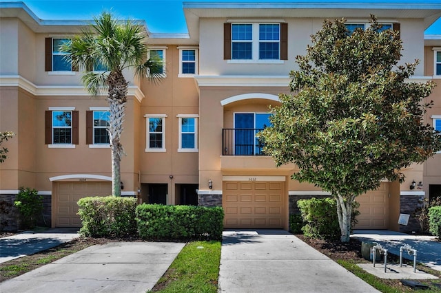 5032 Sand Castle Dr, New Port Richey, FL 34652 - multi unit property with stucco siding, stone siding, a garage, and driveway