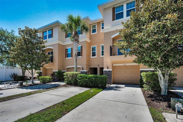 5032 Sand Castle Dr, New Port Richey, FL 34652 - multi unit property with stucco siding, concrete driveway, stone siding, and a garage