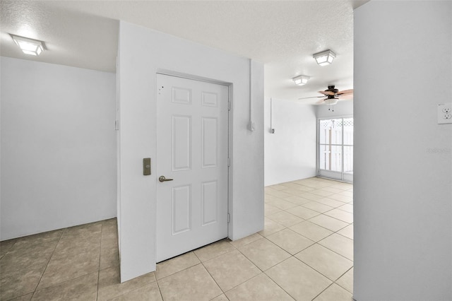 5032 Sand Castle Dr, New Port Richey, FL 34652 - unfurnished room with a ceiling fan, light tile patterned floors, and a textured ceiling