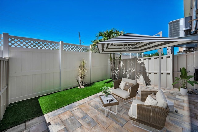 5032 Sand Castle Dr, New Port Richey, FL 34652 - fenced backyard with a patio area and an outdoor hangout area