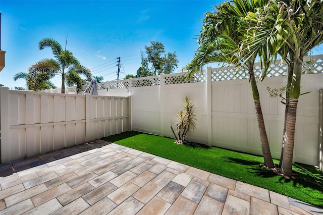5032 Sand Castle Dr, New Port Richey, FL 34652 - fenced backyard with a patio area