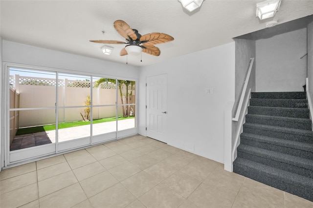 5032 Sand Castle Dr, New Port Richey, FL 34652 - unfurnished room with ceiling fan, stairway, and light tile patterned floors