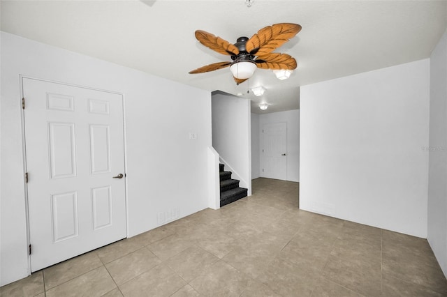 5032 Sand Castle Dr, New Port Richey, FL 34652 - tiled empty room with ceiling fan and stairway