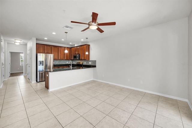 5032 Sand Castle Dr, New Port Richey, FL 34652 - kitchen with appliances with stainless steel finishes, a peninsula, recessed lighting, a ceiling fan, and light tile patterned floors