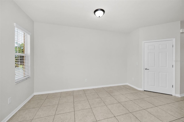 5032 Sand Castle Dr, New Port Richey, FL 34652 - spare room with light tile patterned floors and baseboards