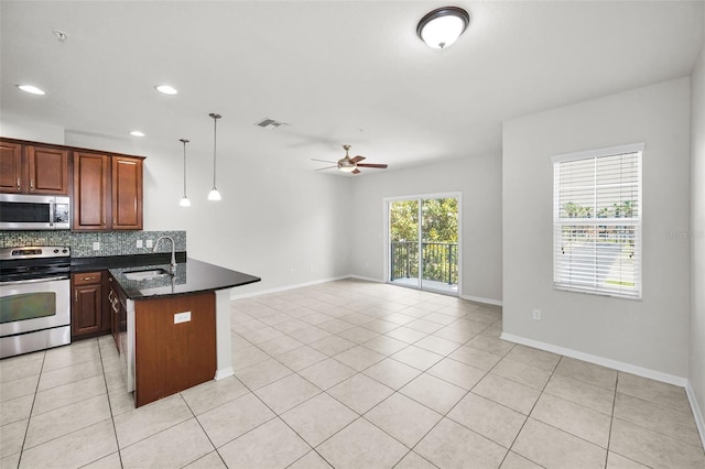 5032 Sand Castle Dr, New Port Richey, FL 34652 - kitchen featuring stainless steel appliances, decorative backsplash, light tile patterned floors, ceiling fan, and open floor plan