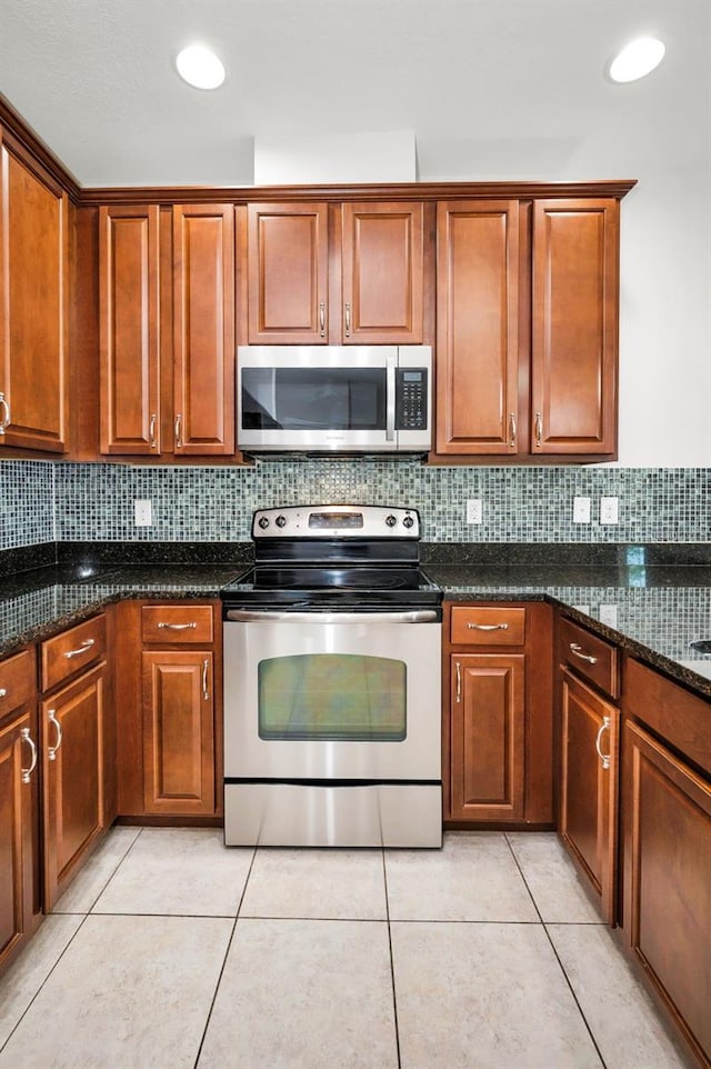 5032 Sand Castle Dr, New Port Richey, FL 34652 - kitchen featuring appliances with stainless steel finishes, tasteful backsplash, dark stone countertops, and brown cabinetry