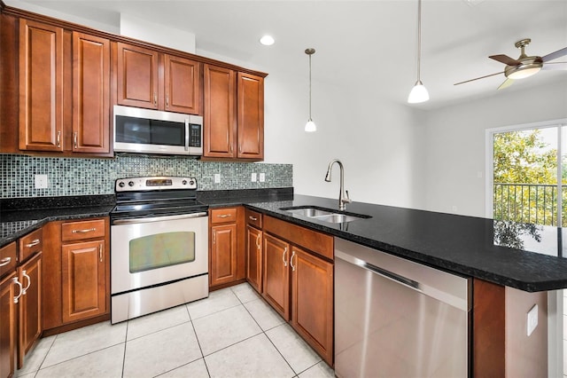 5032 Sand Castle Dr, New Port Richey, FL 34652 - kitchen with appliances with stainless steel finishes, a peninsula, tasteful backsplash, light tile patterned floors, and ceiling fan