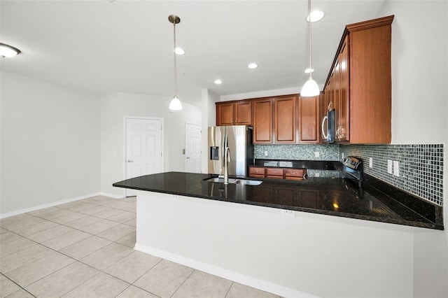 5032 Sand Castle Dr, New Port Richey, FL 34652 - kitchen with stainless steel appliances, a peninsula, brown cabinetry, hanging light fixtures, and backsplash