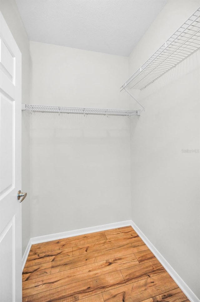 5032 Sand Castle Dr, New Port Richey, FL 34652 - spacious closet featuring wood finished floors