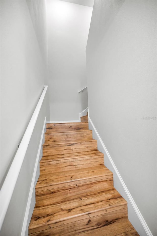 5032 Sand Castle Dr, New Port Richey, FL 34652 - staircase with wood finished floors and baseboards