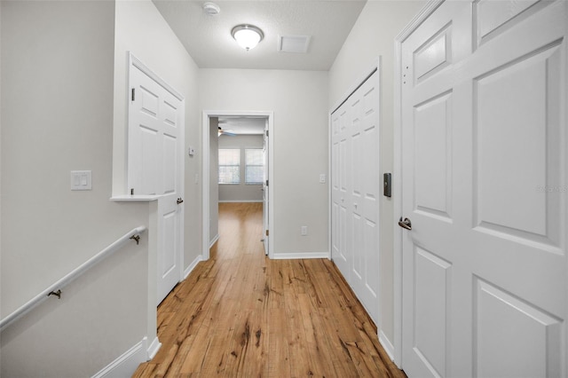5032 Sand Castle Dr, New Port Richey, FL 34652 - hallway featuring light wood-style flooring and baseboards