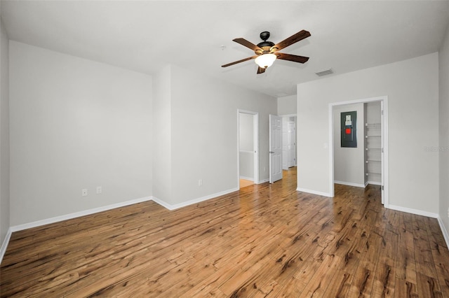 5032 Sand Castle Dr, New Port Richey, FL 34652 - unfurnished bedroom featuring wood finished floors, electric panel, a spacious closet, and ceiling fan