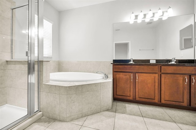 5032 Sand Castle Dr, New Port Richey, FL 34652 - bathroom featuring a bath, double vanity, a shower stall, and tile patterned flooring