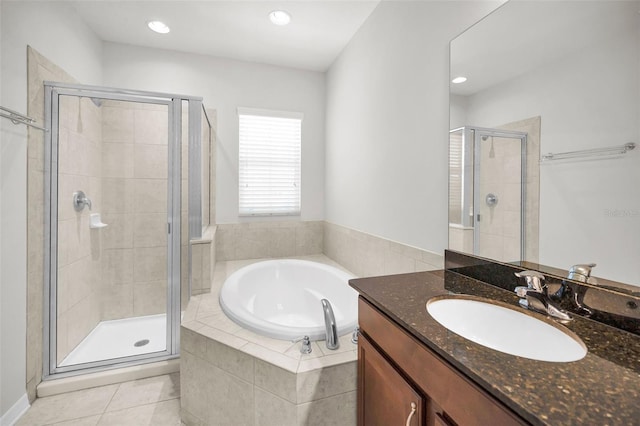 5032 Sand Castle Dr, New Port Richey, FL 34652 - bathroom featuring vanity, a bath, a stall shower, tile patterned floors, and recessed lighting