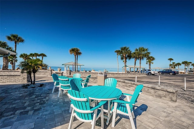 5032 Sand Castle Dr, New Port Richey, FL 34652 - view of patio featuring outdoor dining area and a water view