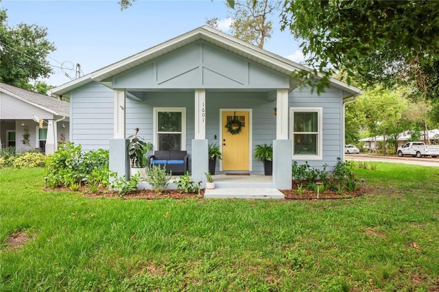 1601 E 98th Ave, Tampa, FL 33612 - bungalow featuring covered porch and a front lawn