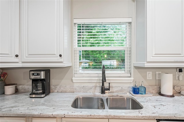 1601 E 98th Ave, Tampa, FL 33612 - kitchen with a sink, white cabinets, and light stone counters