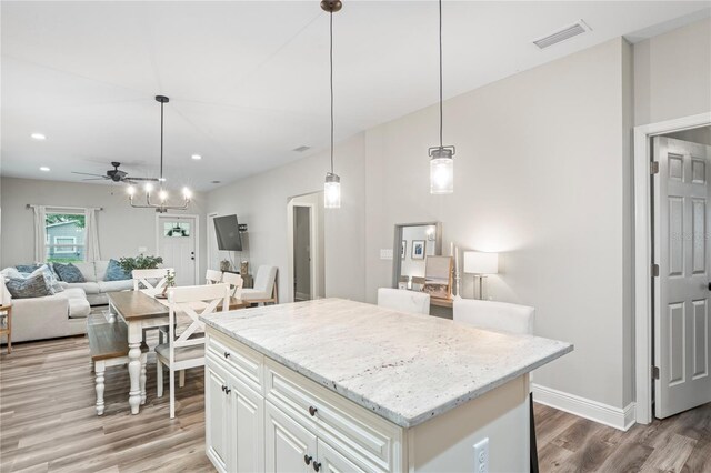 1601 E 98th Ave, Tampa, FL 33612 - kitchen featuring light wood finished floors, a ceiling fan, open floor plan, a center island, and recessed lighting