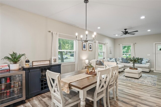 1601 E 98th Ave, Tampa, FL 33612 - dining room with beverage cooler, light wood-style flooring, recessed lighting, a bar, and a chandelier